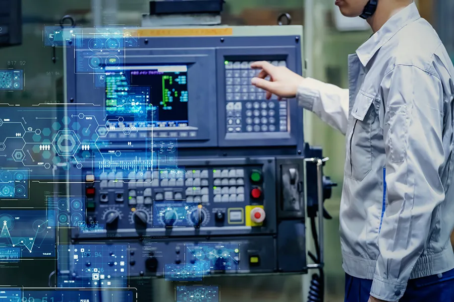 A technician operating a CNC machine with blue holographic overlays projected in front of the control panel.